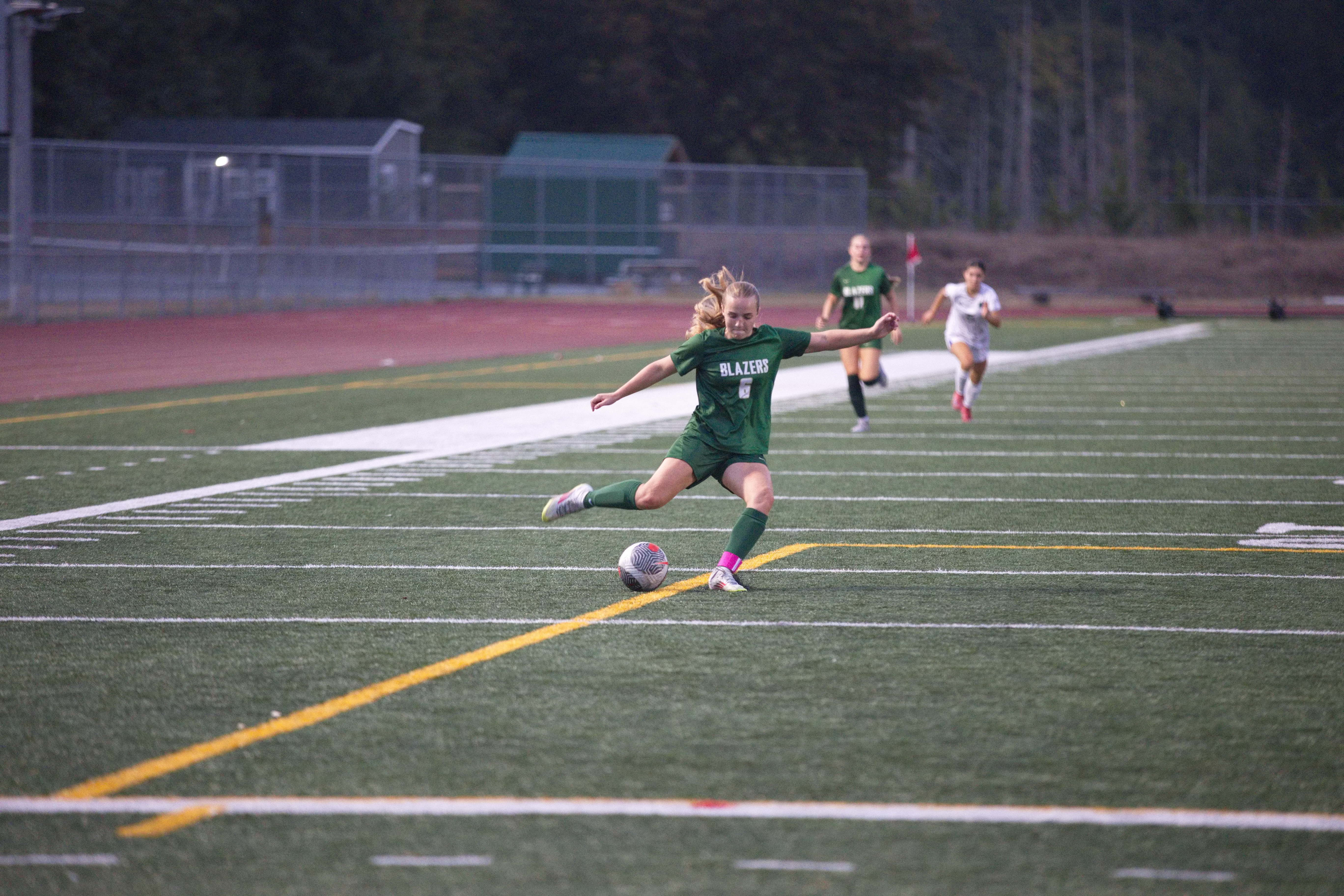A Timberline Blazers soccer player kicking the ball