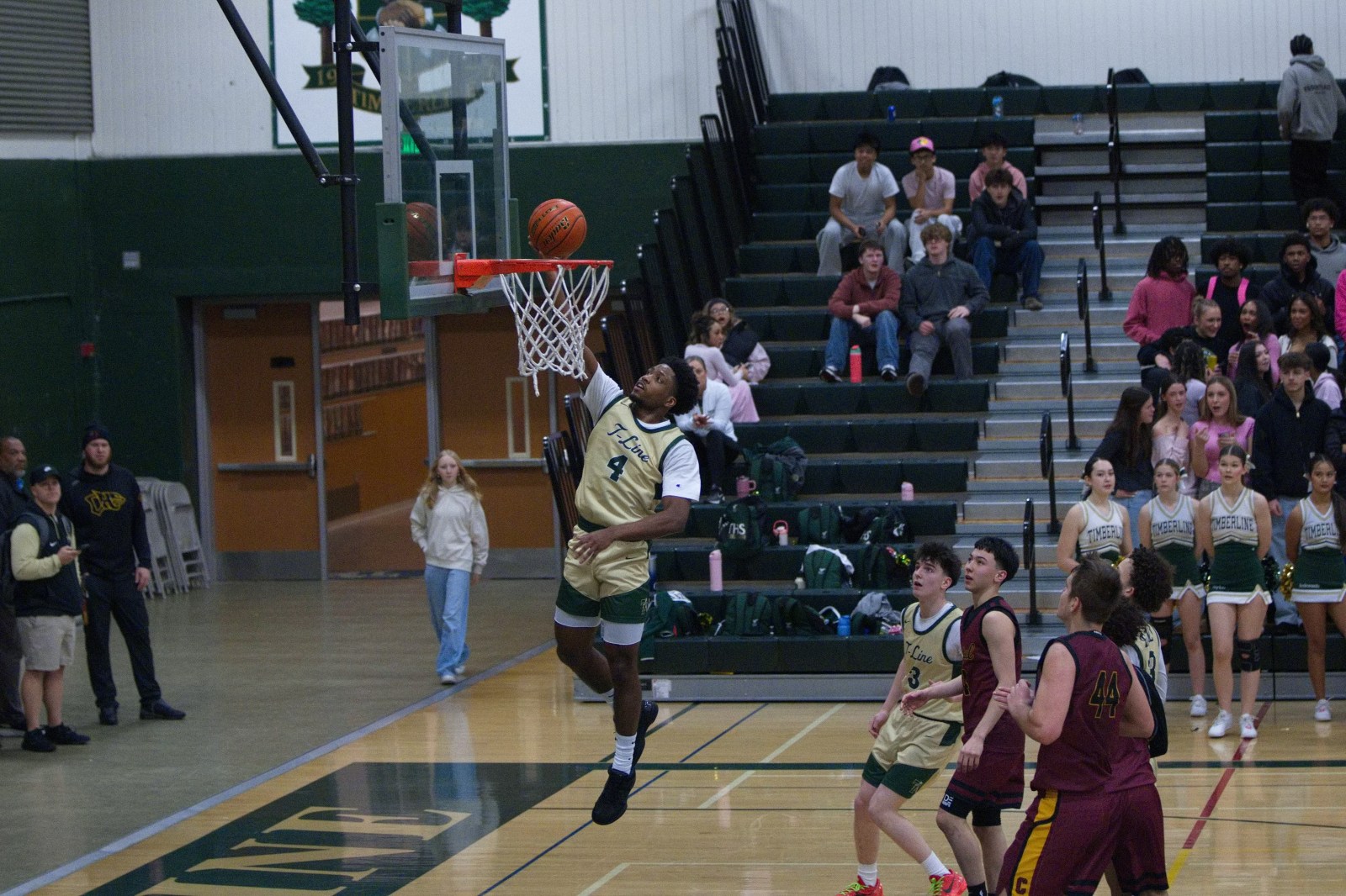 Timberline basketball player dunking during a game